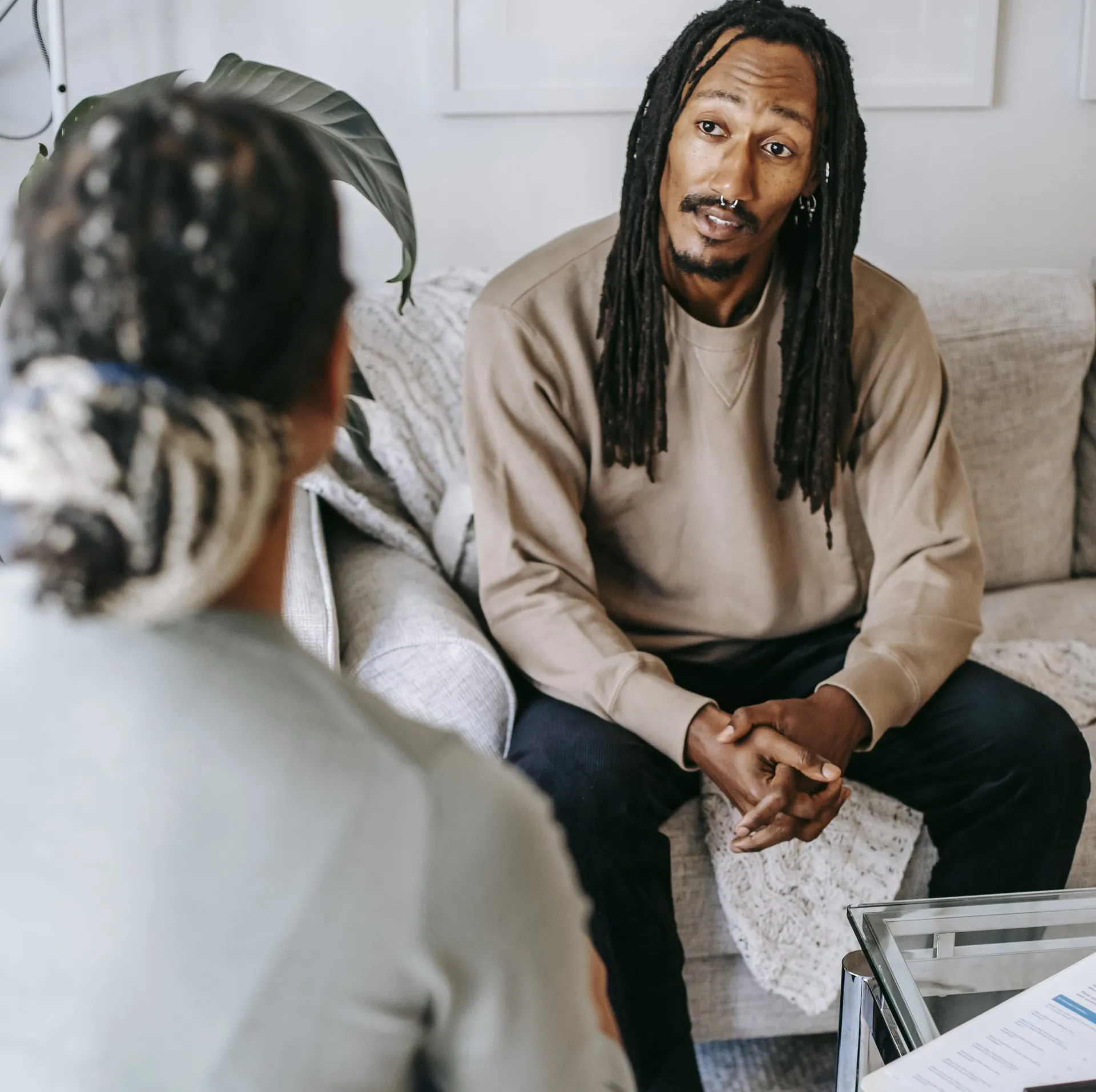 A man having a one-on-one conversation with a financial advisor seated across from him.